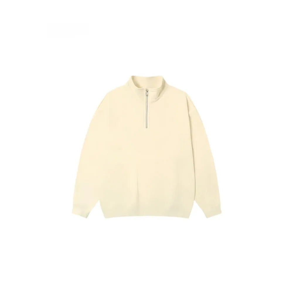 A grey half-zip stand collar cotton sweater laid flat, showing the front zip and long sleeves.