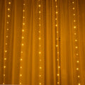 Copper wire curtain string lights with multiple LED bulbs, shown in a choice of blue, purple, or white colours.