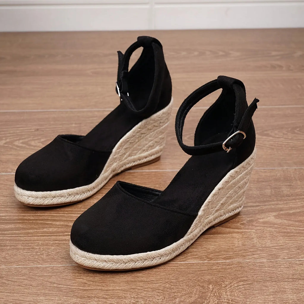 Women's apricot and black canvas wedge sandals with suede detail and a buckle fastening.
