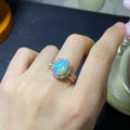 Handmade adjustable silver ring with a natural opal, shown in rose gold plating.