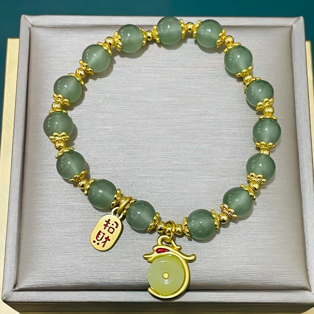 A glass and coloured glaze bracelet with a rabbit motif and a peace buckle clasp.
