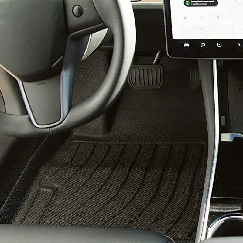 Rubber and TPE floor mat set for a Tesla car interior.