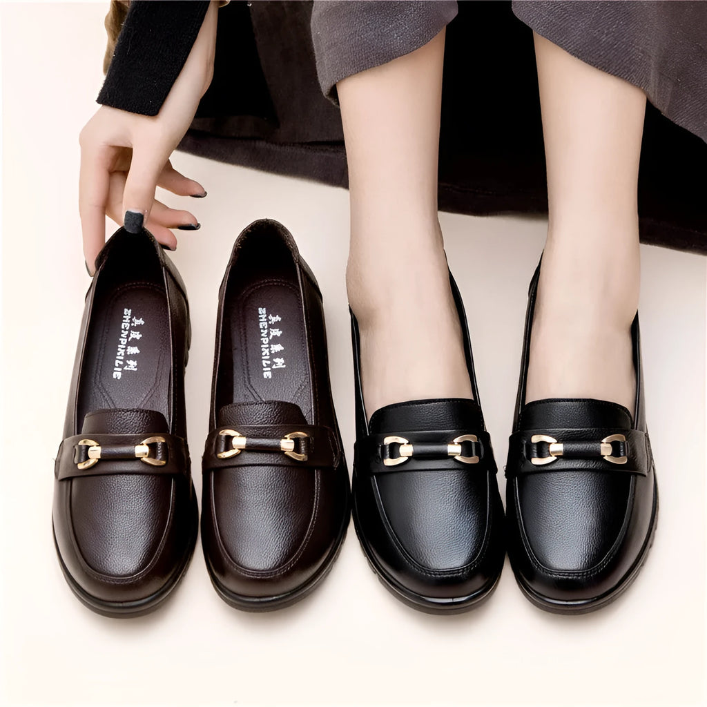 Black women's casual slip-on pumps with round toe and low flat heel on a rubber sole.