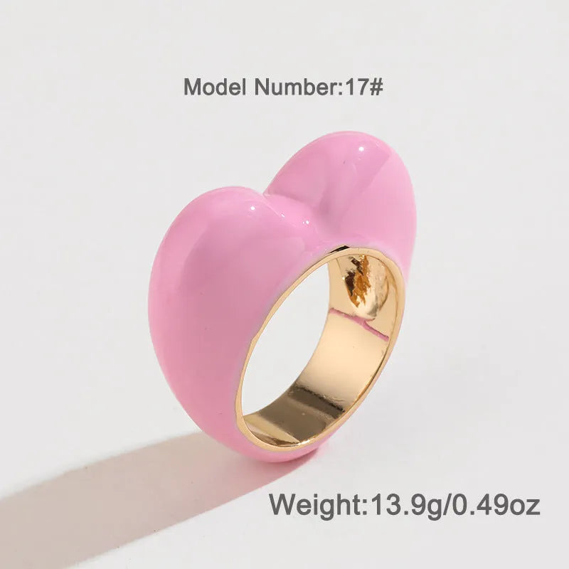 Original three-dimensional enamel heart ring in zinc alloy, shown in black, pink, purple, or red.