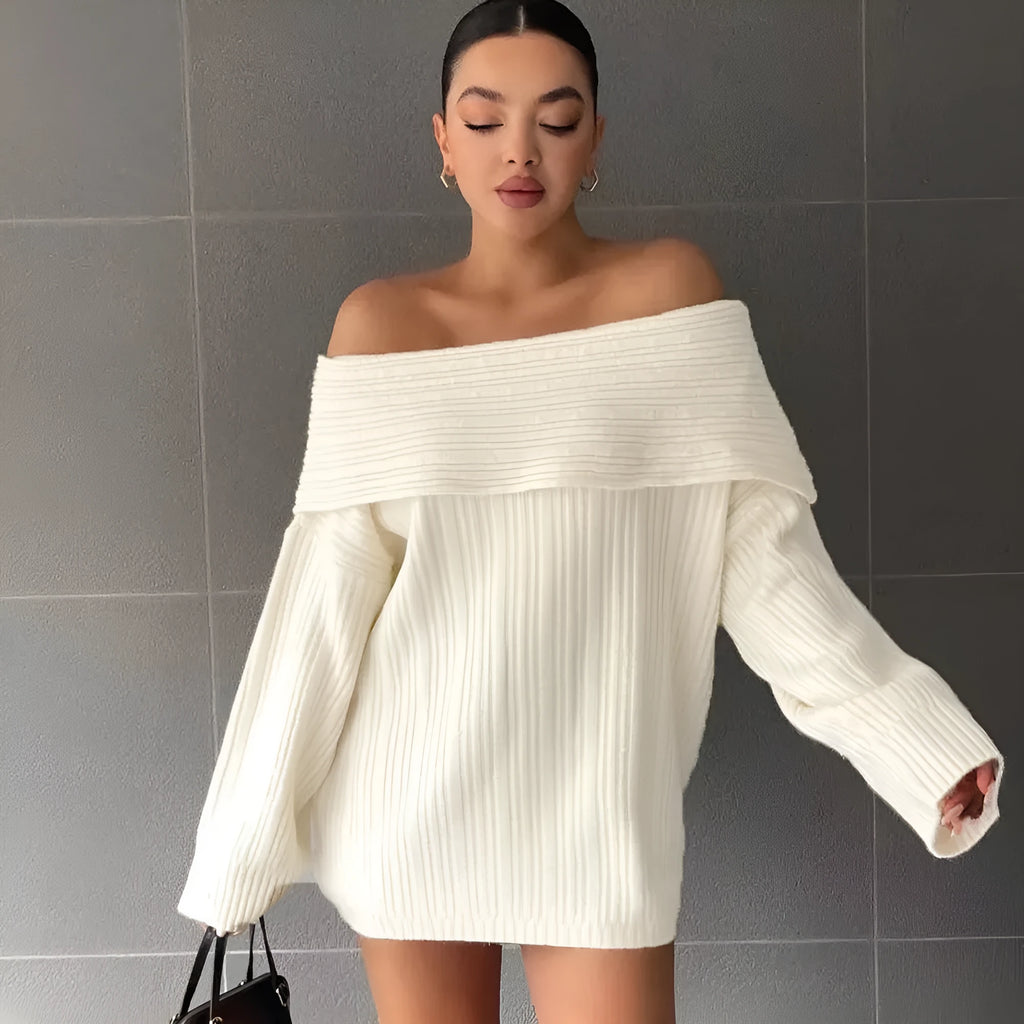 Woman wearing a loose-fitting, long-sleeved, off-neck pullover sweater in a solid colour