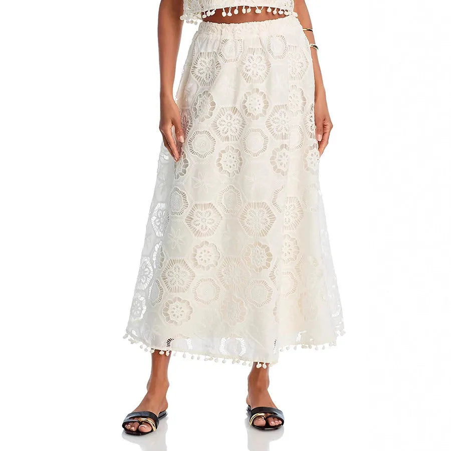 Literary Trends white women's suit set with sleeveless top and embroidered long skirt on a hanger.