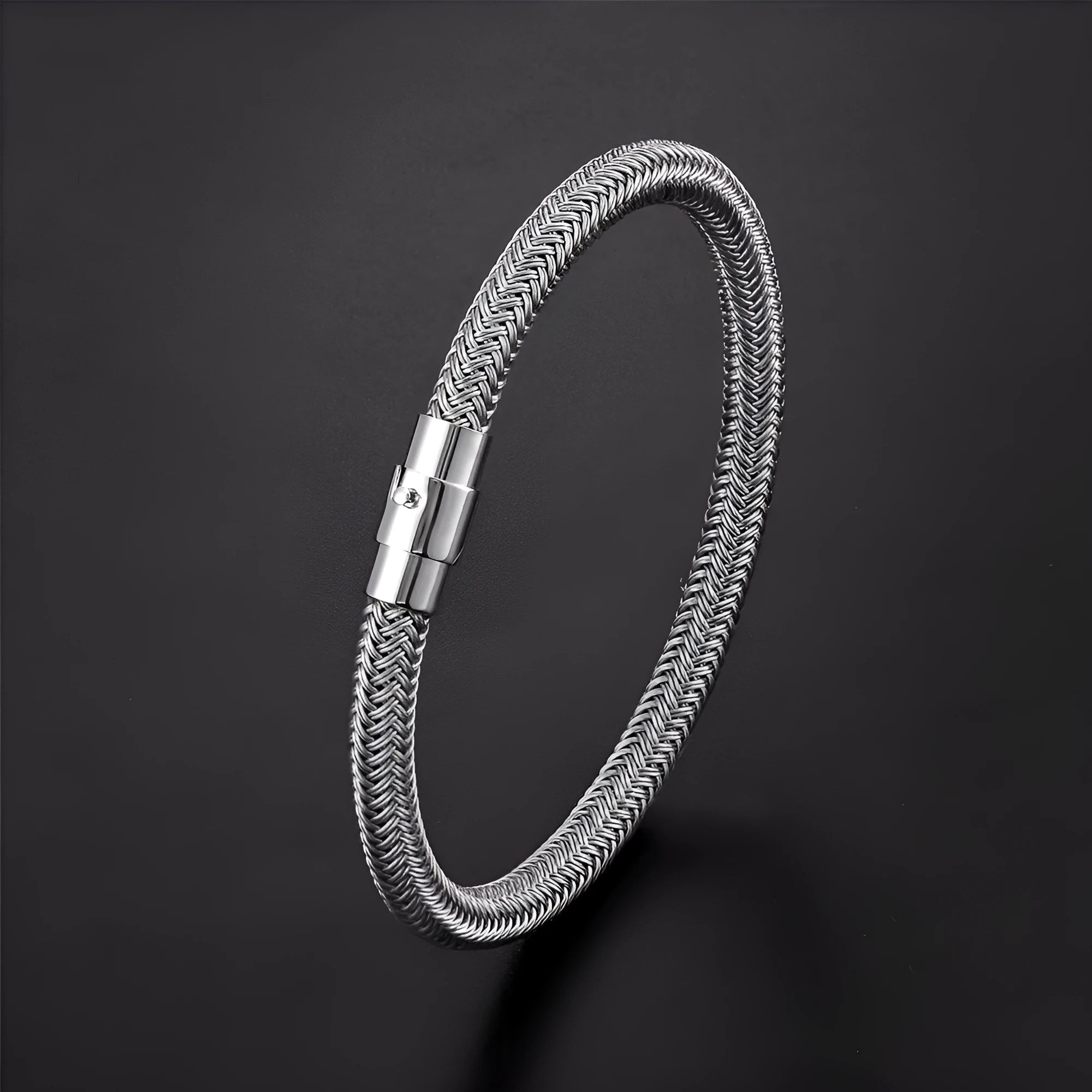 Geometric titanium steel wire bracelet with magnetic clasp on a wrist, shown in a matte grey finish.