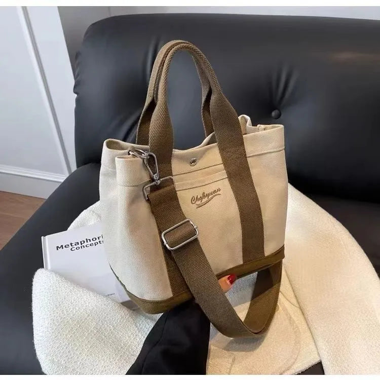 Beige canvas messenger bag with three shoulder straps and sandwich pocket for outdoor and everyday use