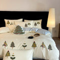 Pure cotton duvet cover and pillowcase set with raised embroidered Christmas tree and floral design in green and cream.