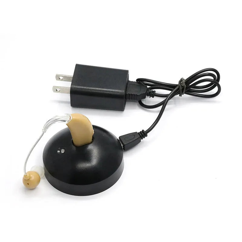 Black rechargeable hearing aid amplifier with silicone earplugs and a charging cable.