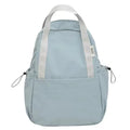 Solid colour nylon backpack in blue with curved straps and a lock, shown in a travel setting.