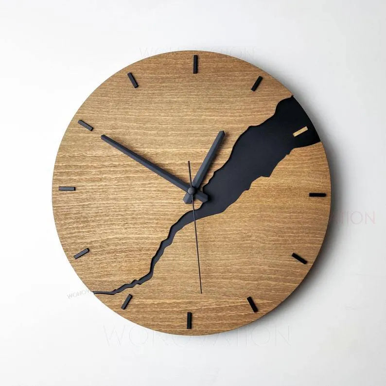Modern wooden wall clock with creative crack design on a white wall.