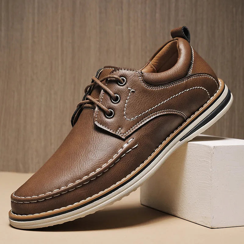 Men's black genuine leather lace-up casual shoes with round toe and rubber sole on a white background