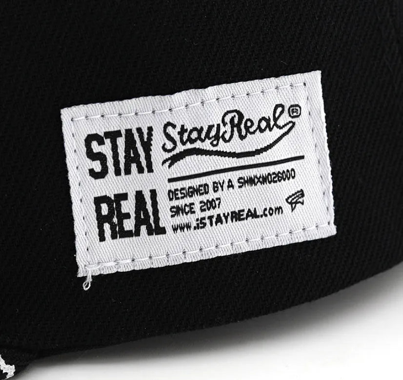 Adjustable black cotton baseball cap with embroidered lettering on the front, showing the dome crown and strap.