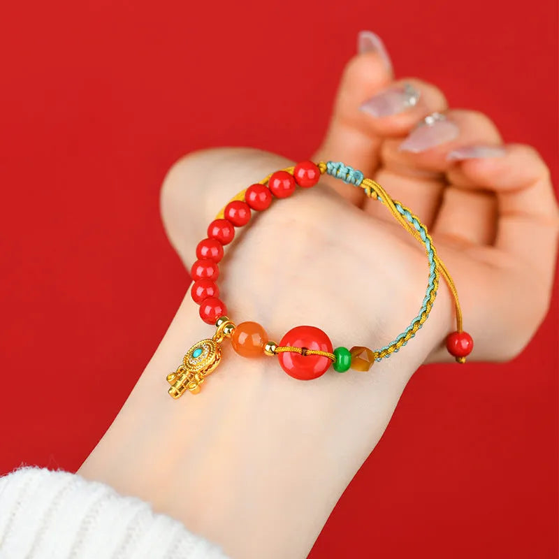Hand-woven cinnabar peace buckle bracelet in emperor red sand colour with geometric design
