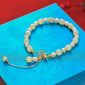 Women's bracelet with natural Hetian jade pearl pendant and gold-coloured alloy components