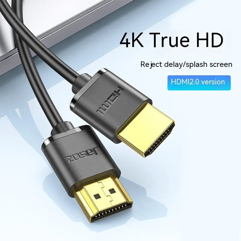 Gold-plated HDMI to HDMI cable with thin flexible wire on a white background.