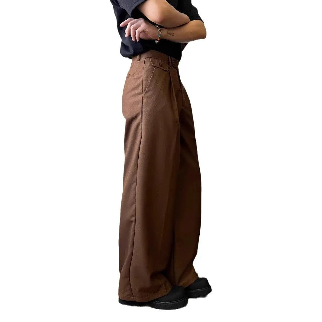 Man wearing brown straight wide-leg casual suit trousers made from a polyester blend fabric.