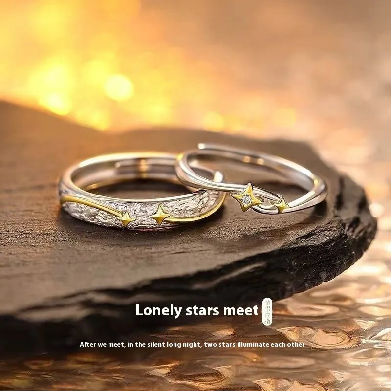 Pair of copper electroplated meteor shower star couple rings with adjustable opening on a flat surface