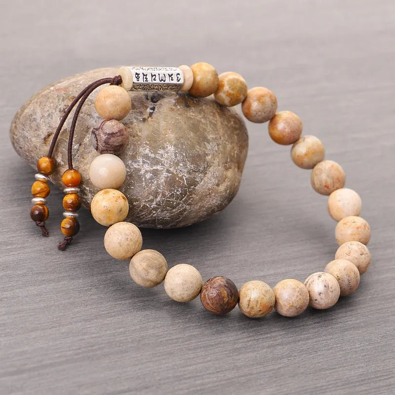Handmade wood colour stone bead bracelet with adjustable closure on wooden background