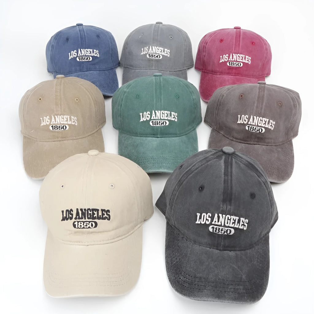 Retro distressed beige cap with adjustable strap and embroidered letters on a conical crown.