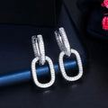 U-shaped geometric copper earrings for women with inlaid zircon, shown in white gold colour and yellow gold colour options.
