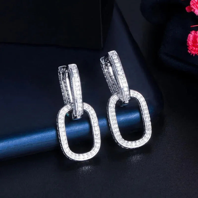 U-shaped geometric copper earrings for women with inlaid zircon, shown in white gold colour and yellow gold colour options.