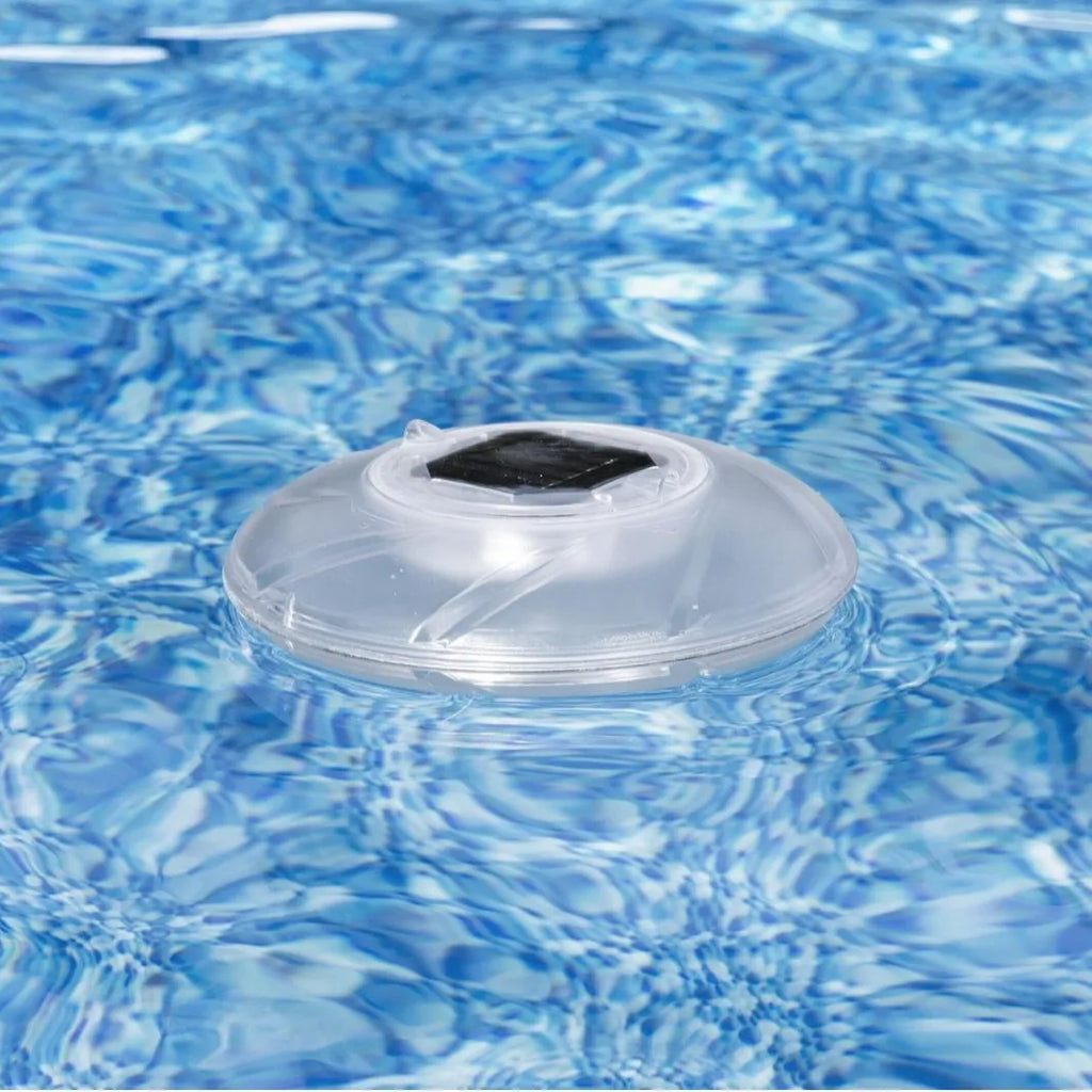 Bestway 58111 solar floating light floating on pool water surface with sunlight reflecting