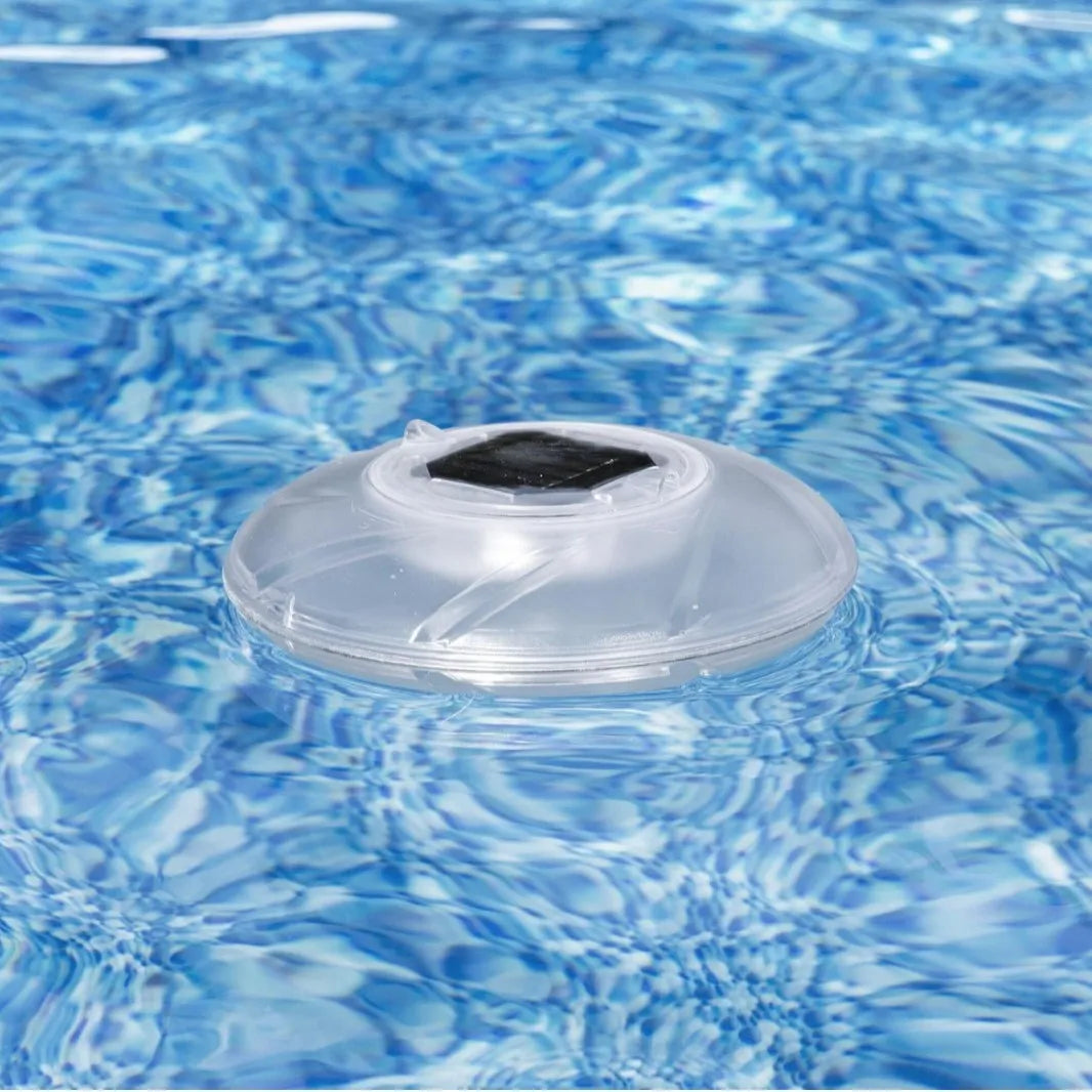 Bestway 58111 solar floating light floating on pool water surface with sunlight reflecting