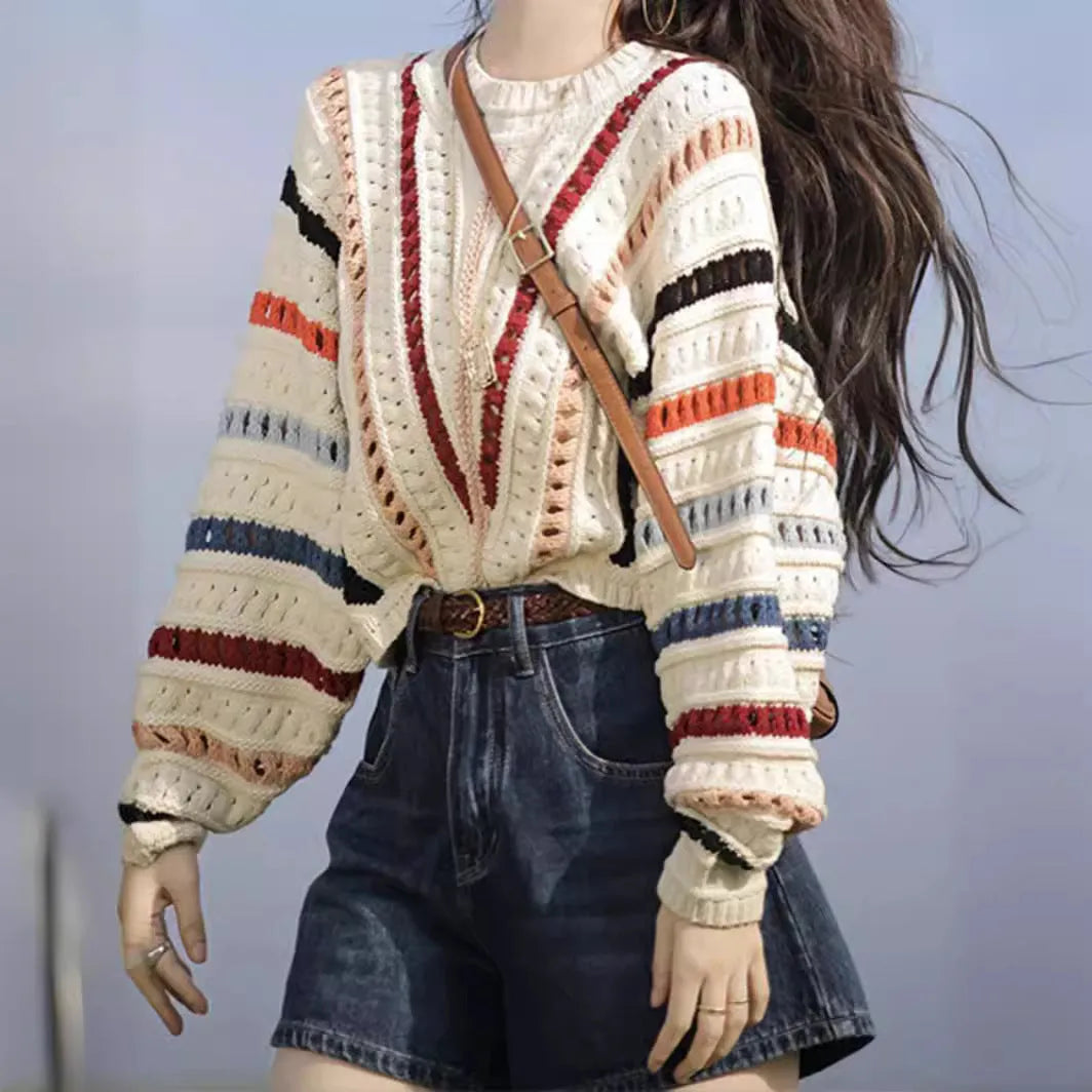 Colourful rainbow striped loose-fit pullover sweater with batwing sleeves and a round neck.