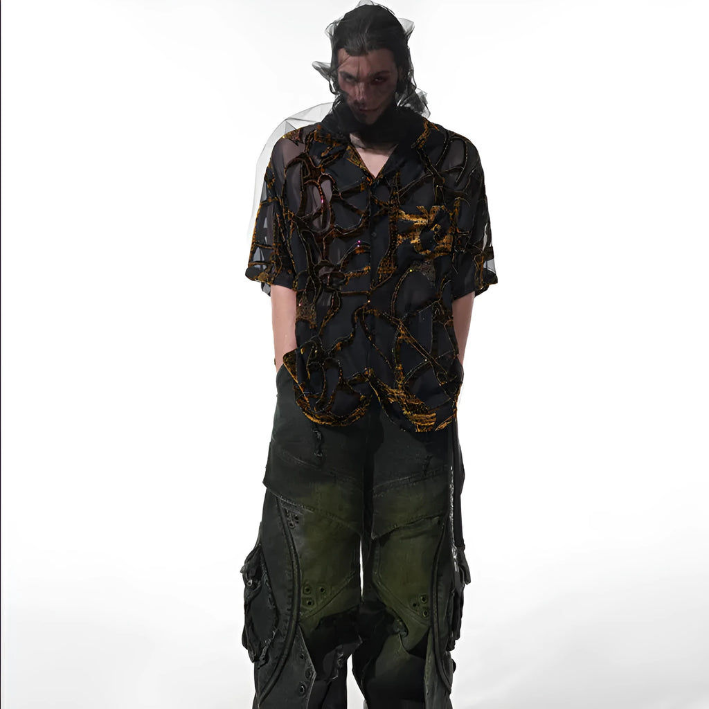 Man wearing a black and grey translucent snake pattern short-sleeved shirt with a lapel collar.