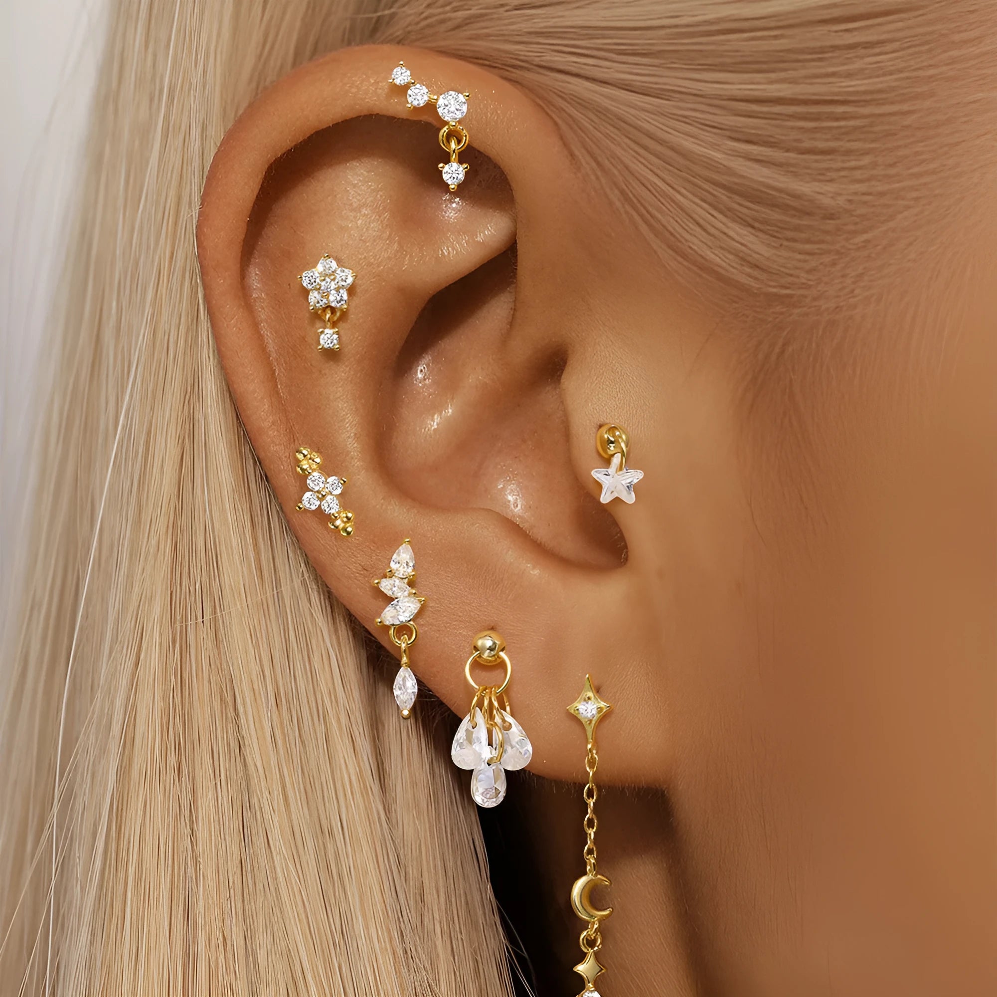 S925 sterling silver moon and star shaped earrings with diamond details on a gold-tone finish.