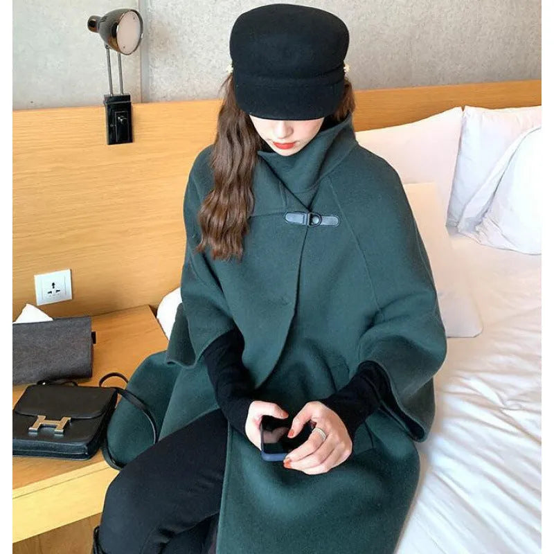 Women's long oatmeal-coloured acrylic coat with half-length flight sleeves, shown on a model.