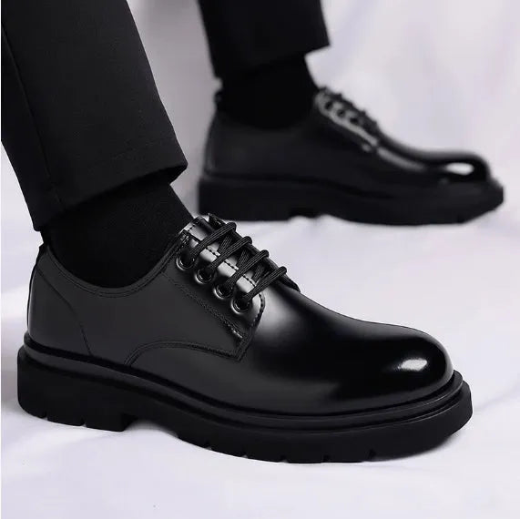 Men's black round-toe leather shoes with thick rubber sole and lace-up closure