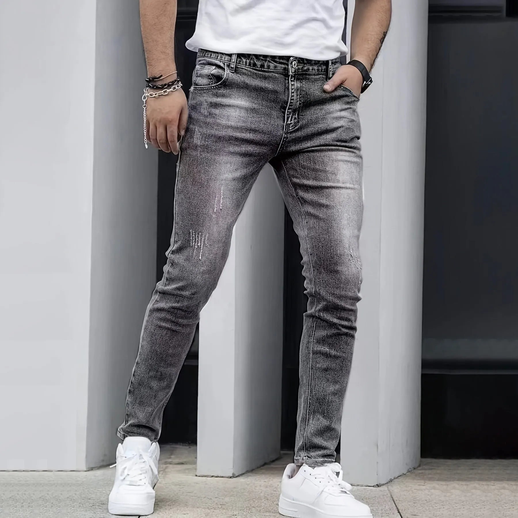 A pair of men's solid colour stretch jeans in a straight leg skinny fit, shown in dark blue.