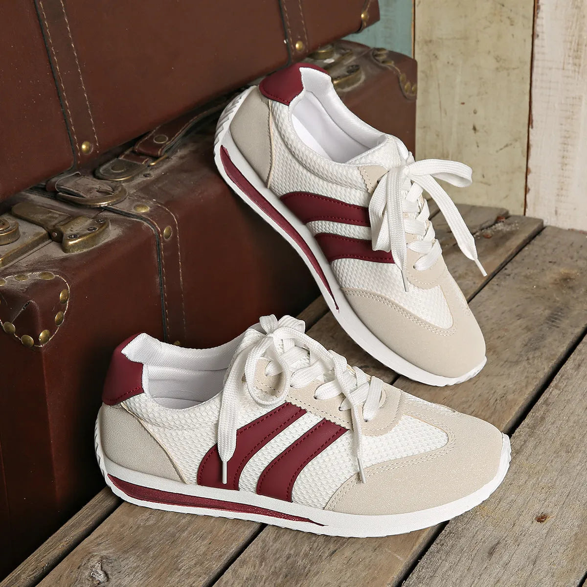 Wine red Cortez retro-style low-top sneaker with a cross-strap over a breathable mesh upper.