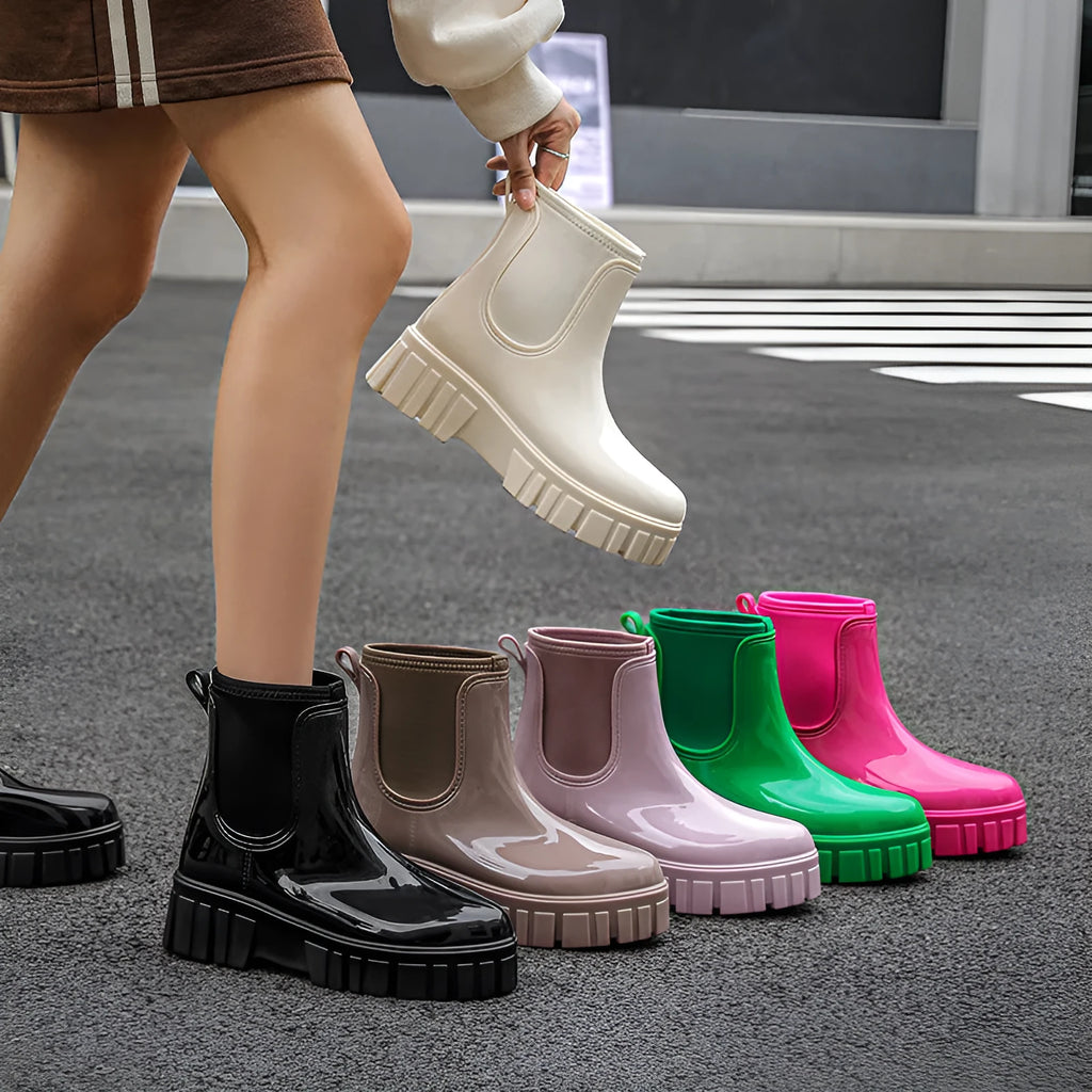 Creamy-white low tube PVC rain boots with a flat heel and non-slip sole on a plain background.