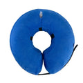 Blue inflatable soft recovery collar for a dog resting after surgery.