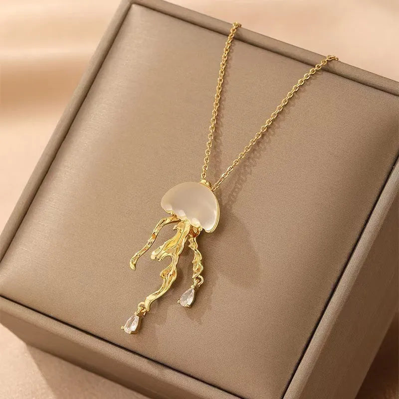 18K gold titanium steel openwork jellyfish pendant on silver O-ring chain against white background