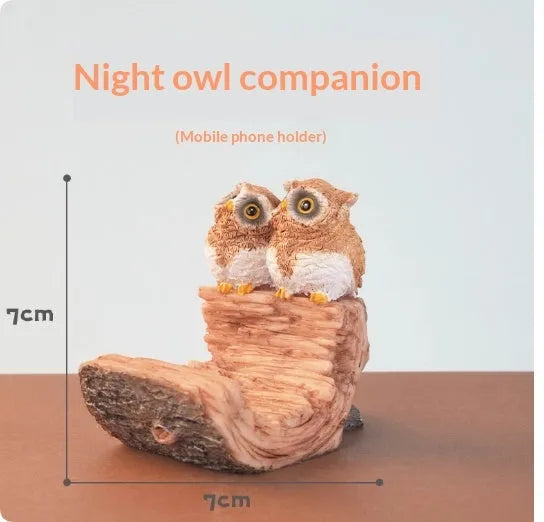 Creative desktop phone stand with animal design on bedside table holding smartphone for TV viewing