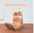 Creative desktop phone stand with animal design on bedside table holding smartphone for TV viewing