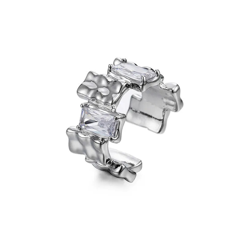 Silver plated open ring with cross design and zircon crystals.