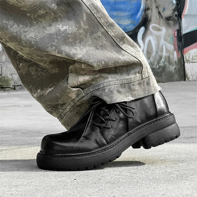Black low-top platform leather shoes with round toe and rubber sole