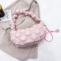 Women's light beige nylon cloud underarm messenger bag with a long adjustable shoulder strap.