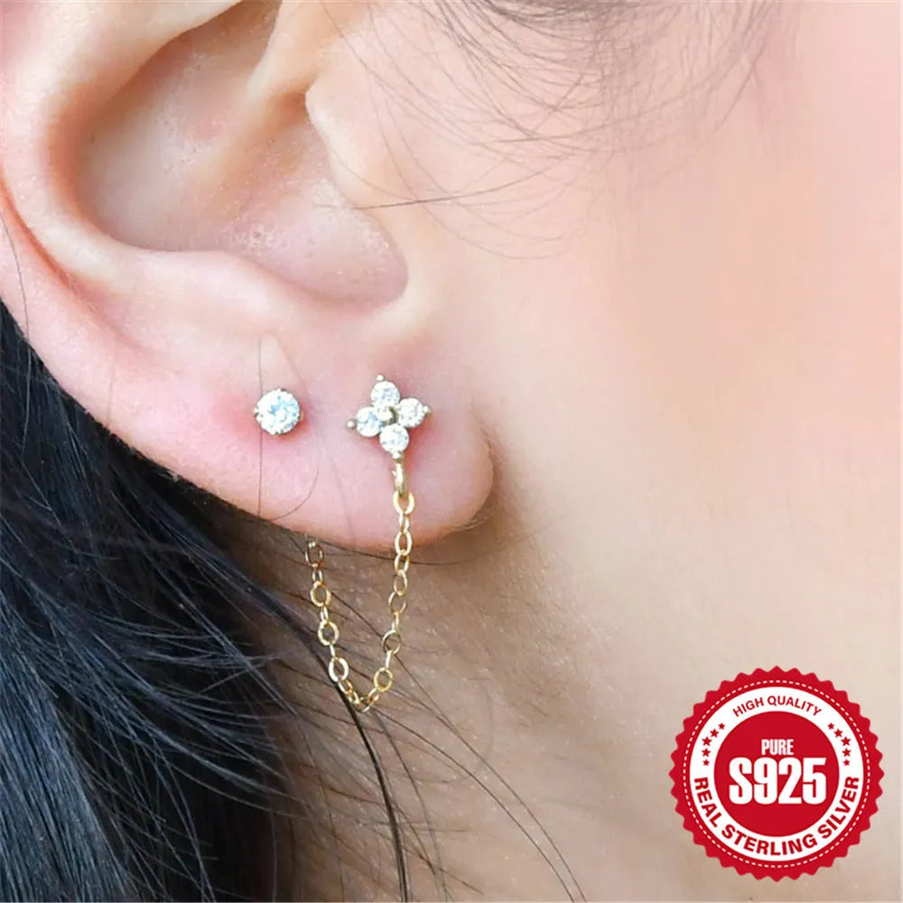 S925 sterling silver geometric stud earrings with diamond, flower, and tassel chain design in a golden colour.