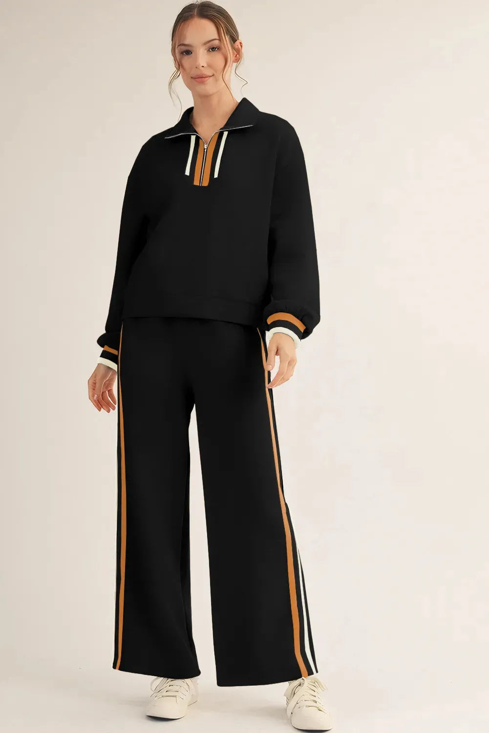 Black striped patchwork quarter zip pullover and loose trousers set on a model