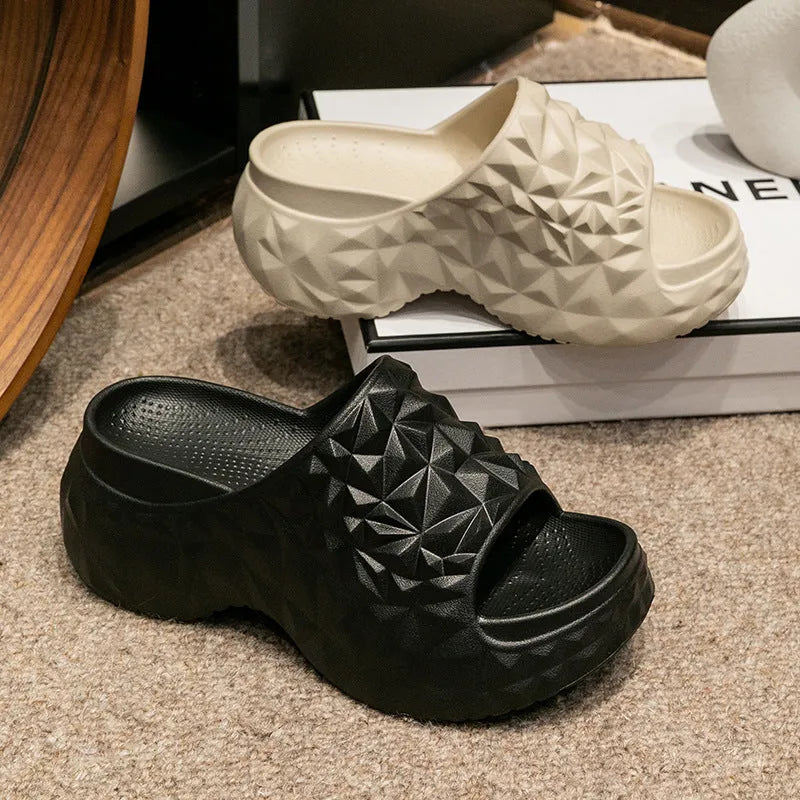 A pair of khaki high heel flip flop slippers made from injection moulded EVA with a thick sole.