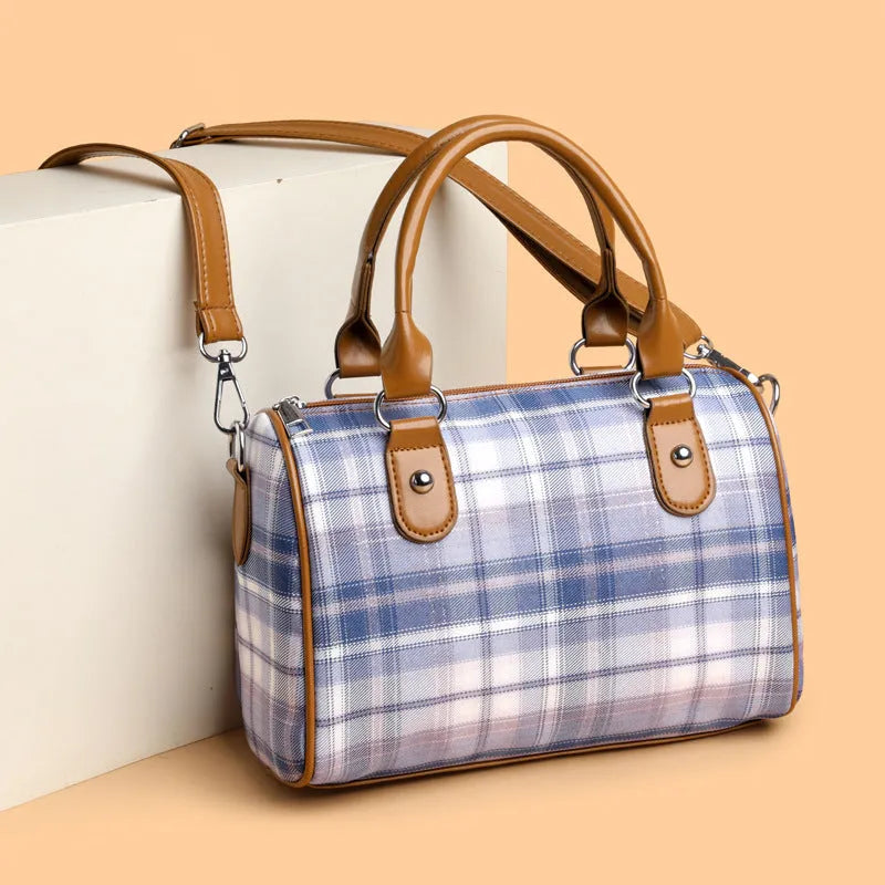 Plaid academy style round barrel canvas shoulder bag with three-dimensional pocket, available in blue plaid.