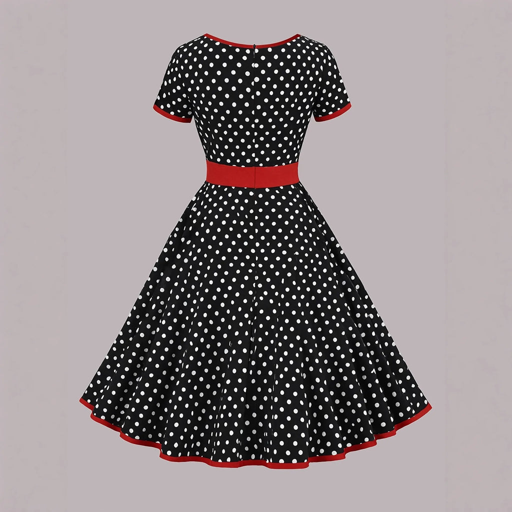 Multicolour polka dot dress with square neckline, short sleeves, front zip, and a pleated midi skirt.