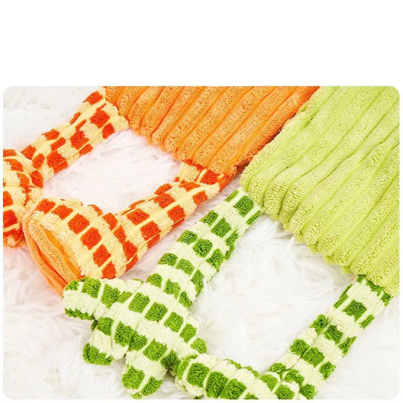 Green and orange durable rubber dog toy with squeaker for aggressive chewers.